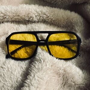 Aviator-style sunglasses. Black Frame Sunglasses with Yellow Lenses